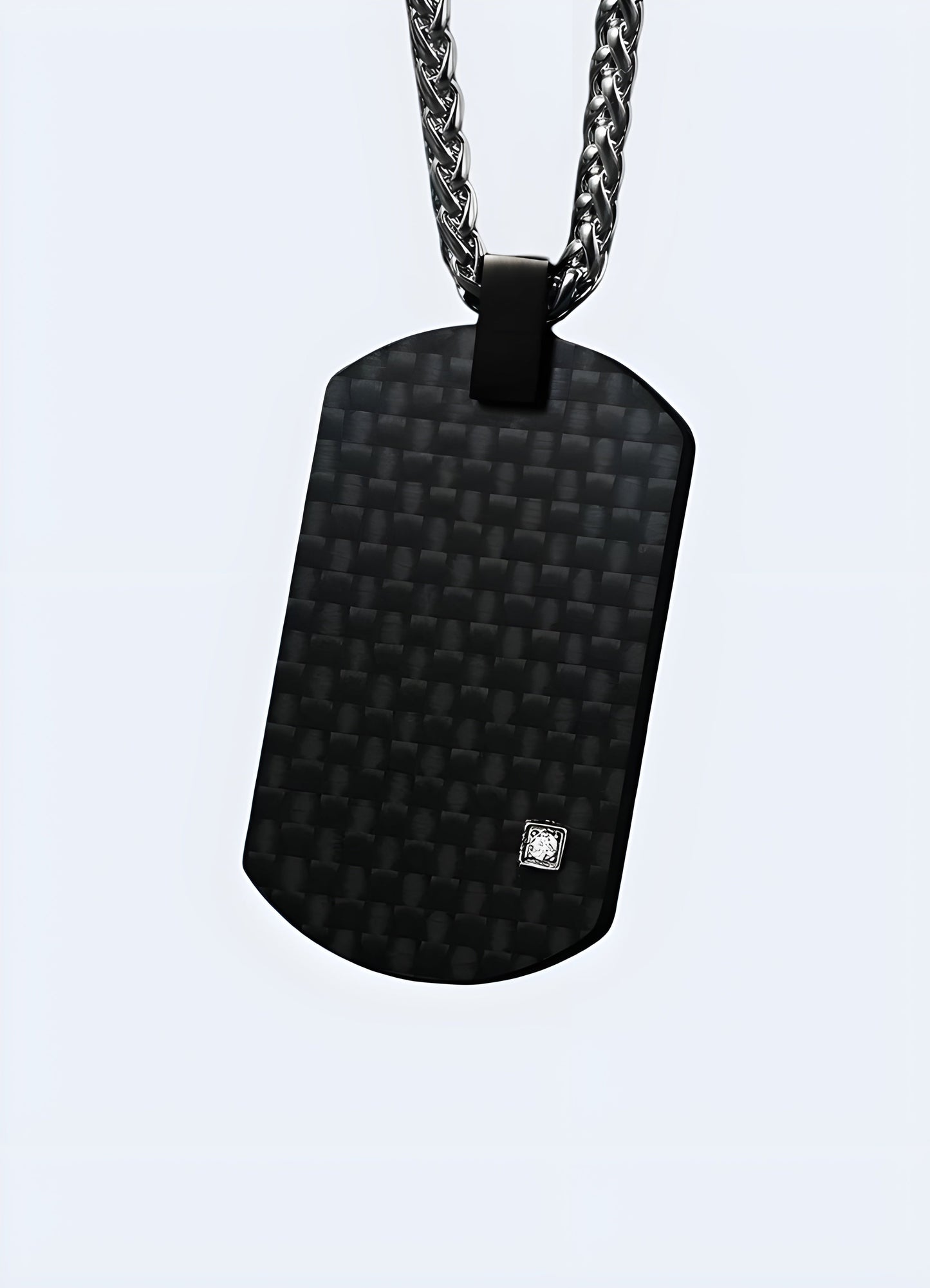 Front view of a carbon fiber techwear pendant from the Canada, highlighting its sleek and modern design.