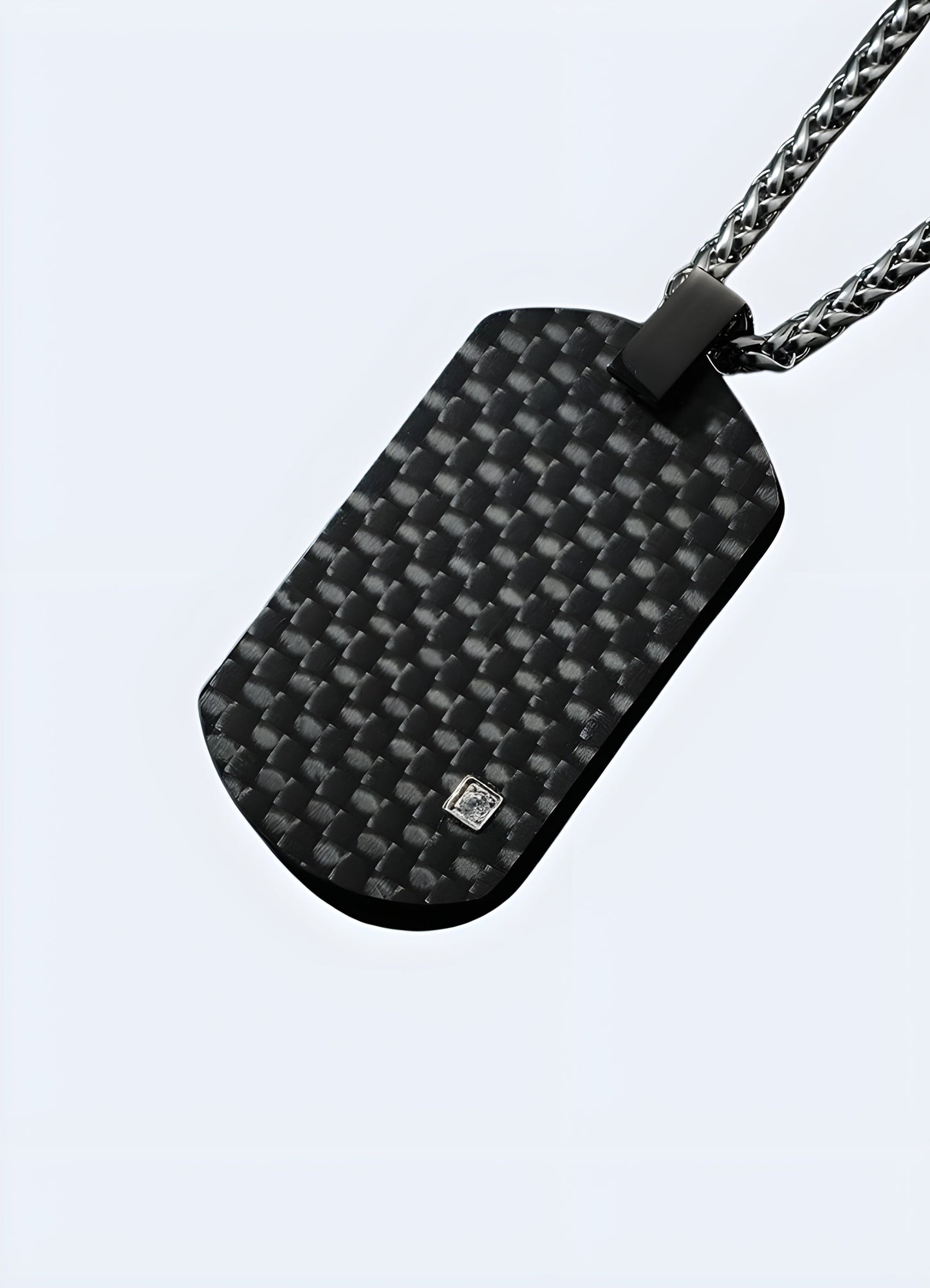 Front view of a black carbon fiber techwear pendant from the Canada, showcasing its sleek and futuristic design.