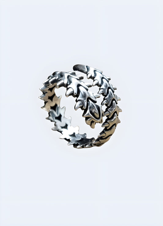 The ring features a design inspired by a centipede, with a series of detailed, segmented elements encircling the band to resemble a centipede's body.