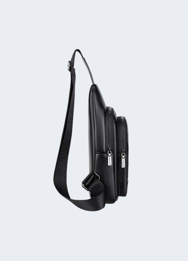 Model wearing a leather chest bag, viewed from the side. The bag features a sleek, smooth leather finish, with a streamlined design Canada.