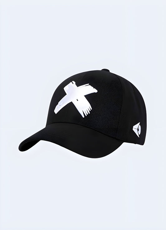 A black cap with a prominent cross design on the front, shown from the front view.