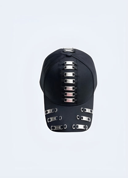 A black darkwear cap featuring metal frame tags, shown from the front to highlight its design. This style is influenced by contemporary Canadian fashion.