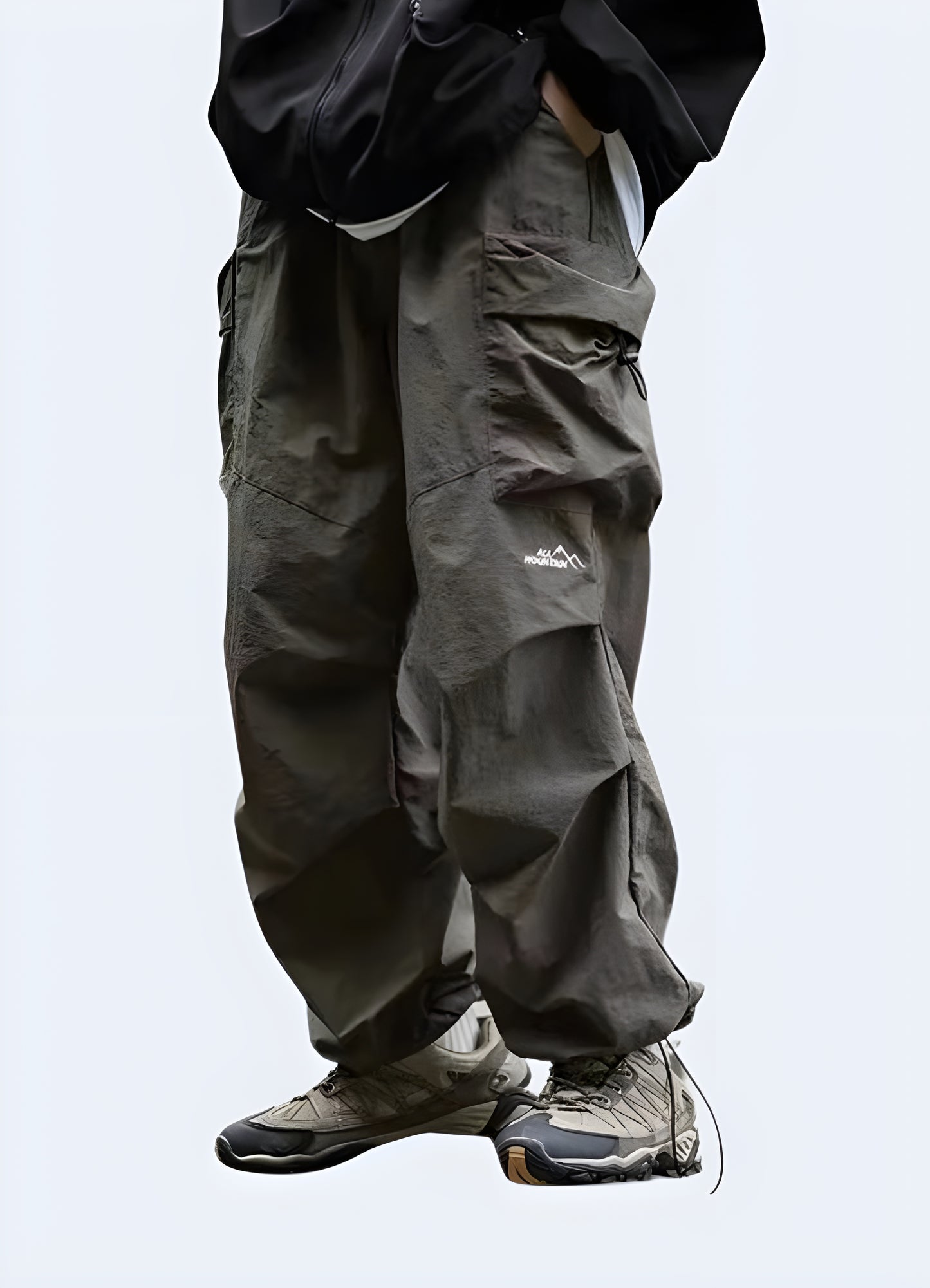 Stylish green parachute pants with drawstring waist and tapered leg, perfect for casual wear or outdoor activities.