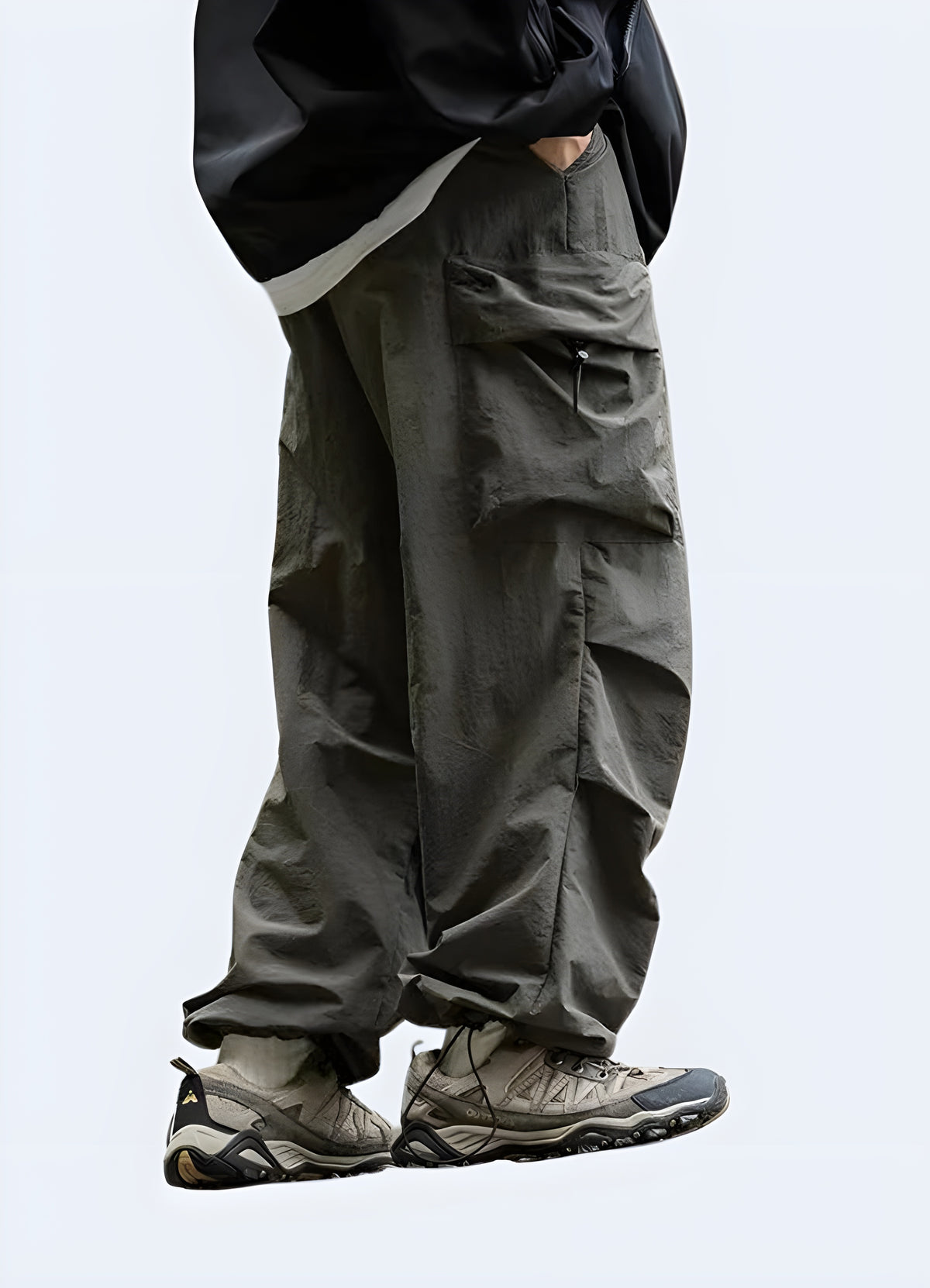 Detail of the green cargo pants showing pocket placement and the loose parachute drape at the hem
