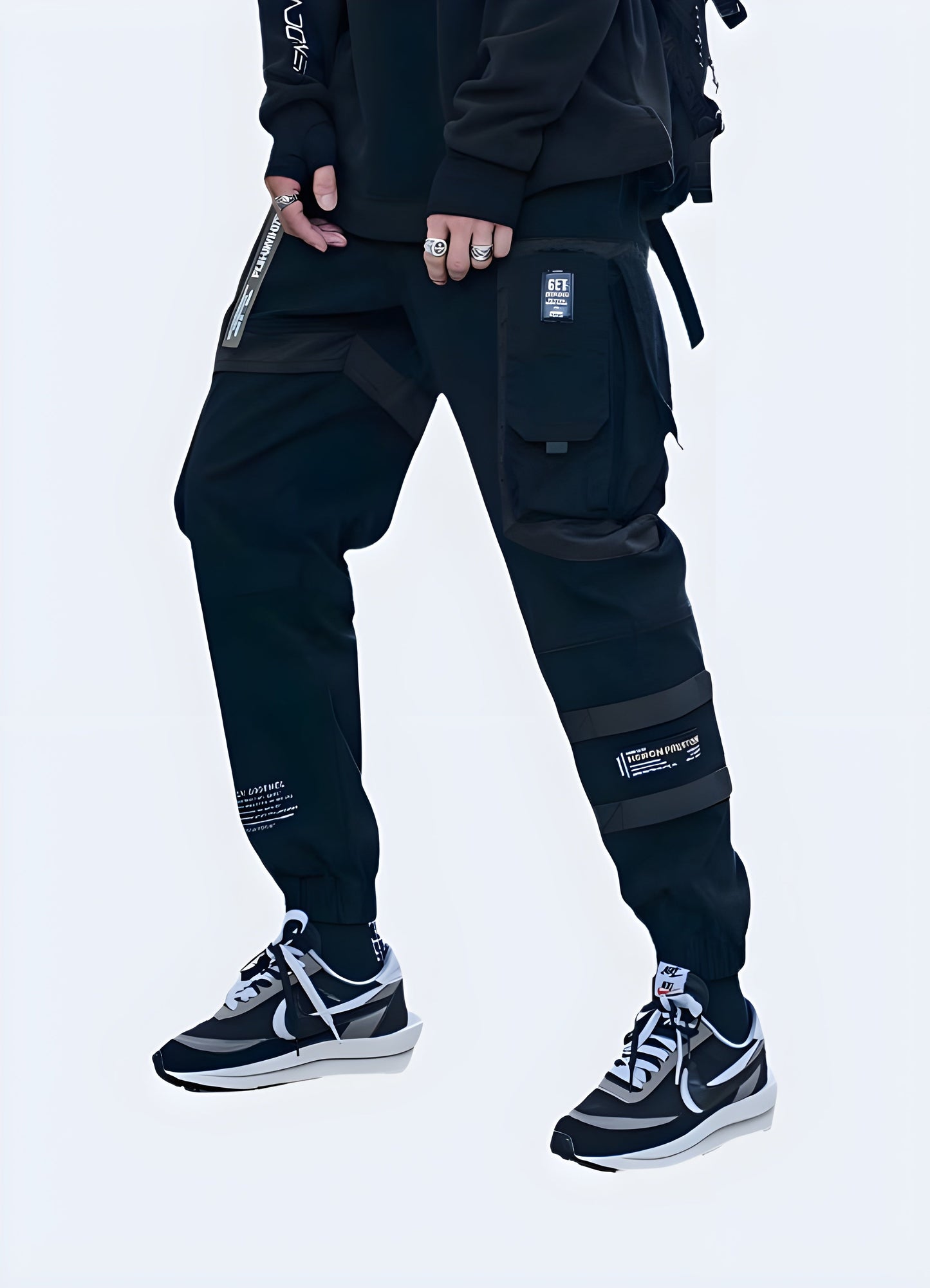 Man modeling baggy techwear pants from the front and side, showcasing the relaxed fit and stylish design popular in Canada.