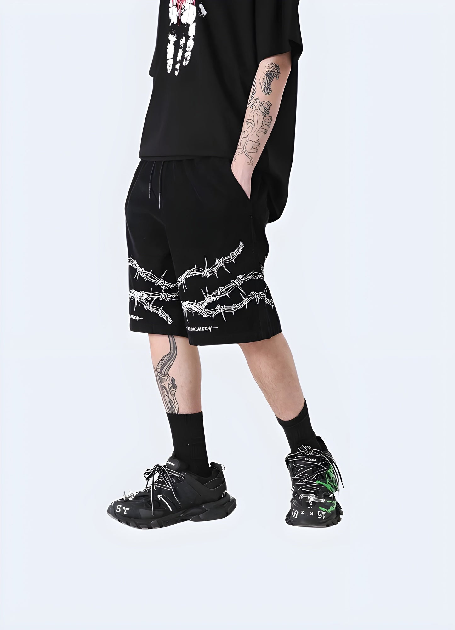 Front side view of a man wearing barbed wire shorts, highlighting the unconventional style and attention-grabbing details, suitable for the alternative fashion enthusiast Canada.