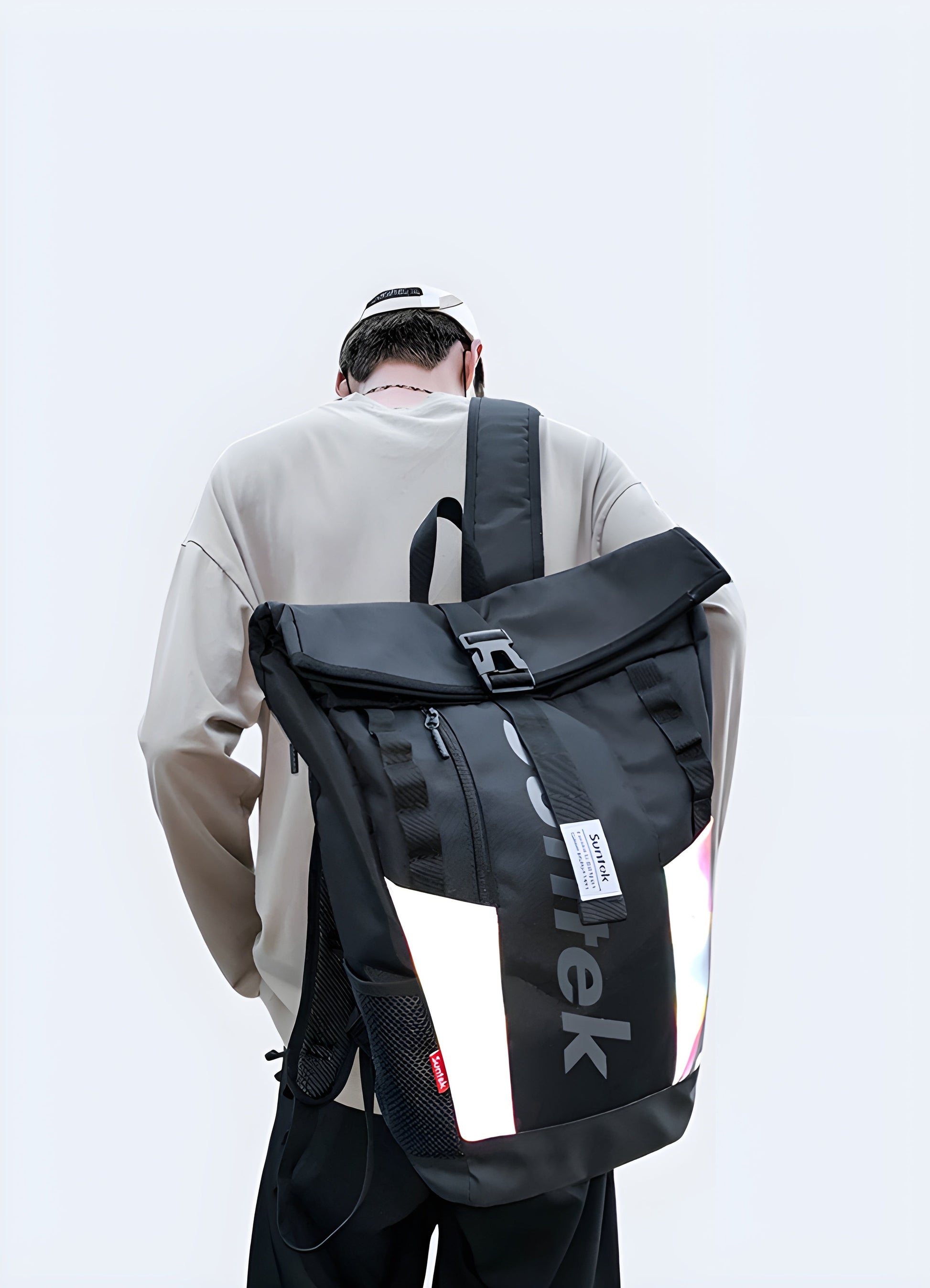 A man wearing a black reflective backpack, viewed from the side. The backpack has a shiny, reflective surface and a sleek, modern design Canada.