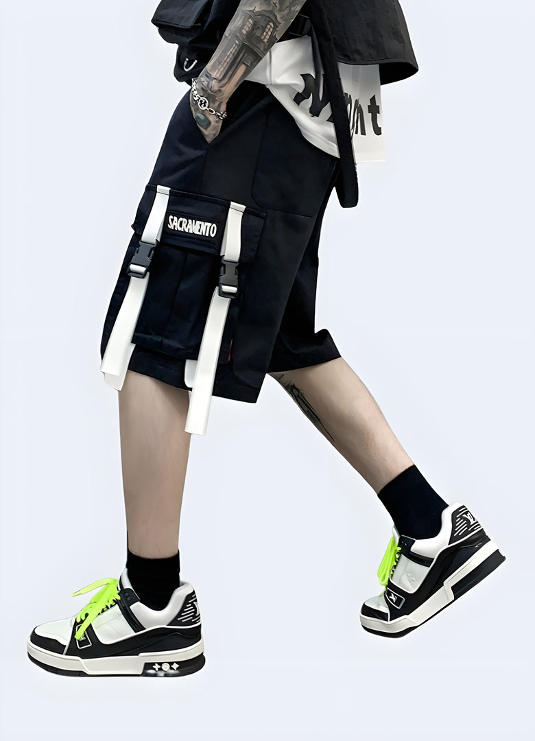 Side view of a man wearing black and white cargo shorts, showcasing the monochromatic design and modern features, perfect for the fashion-conscious individual Canada.