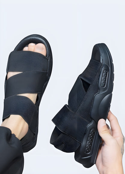 Man wearing black ninja sandals, front side view, available in Canada, highlighting their contemporary look and versatile design.