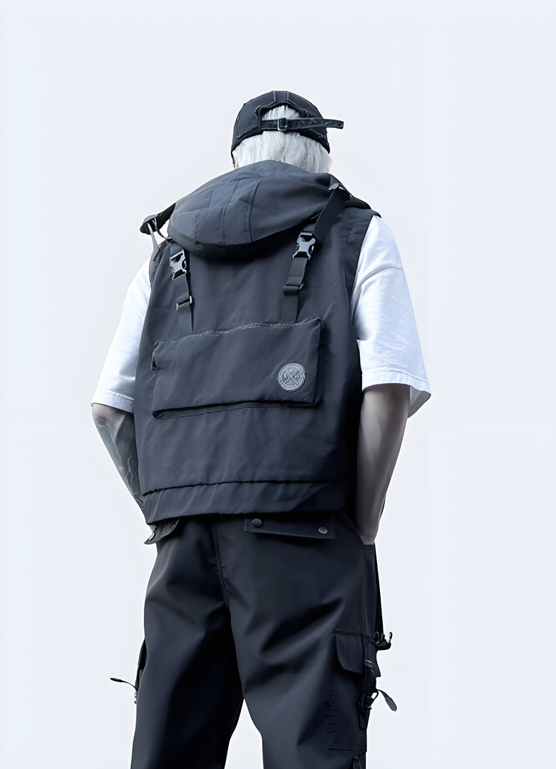Man wearing a stylish black techwear vest with hood, shown from the back view, available in Canada
