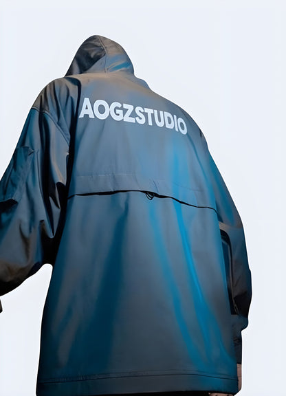 Back view of a man wearing a blue techwear jacket, highlighting its streamlined silhouette and innovative features, perfect for active Canada consumers.