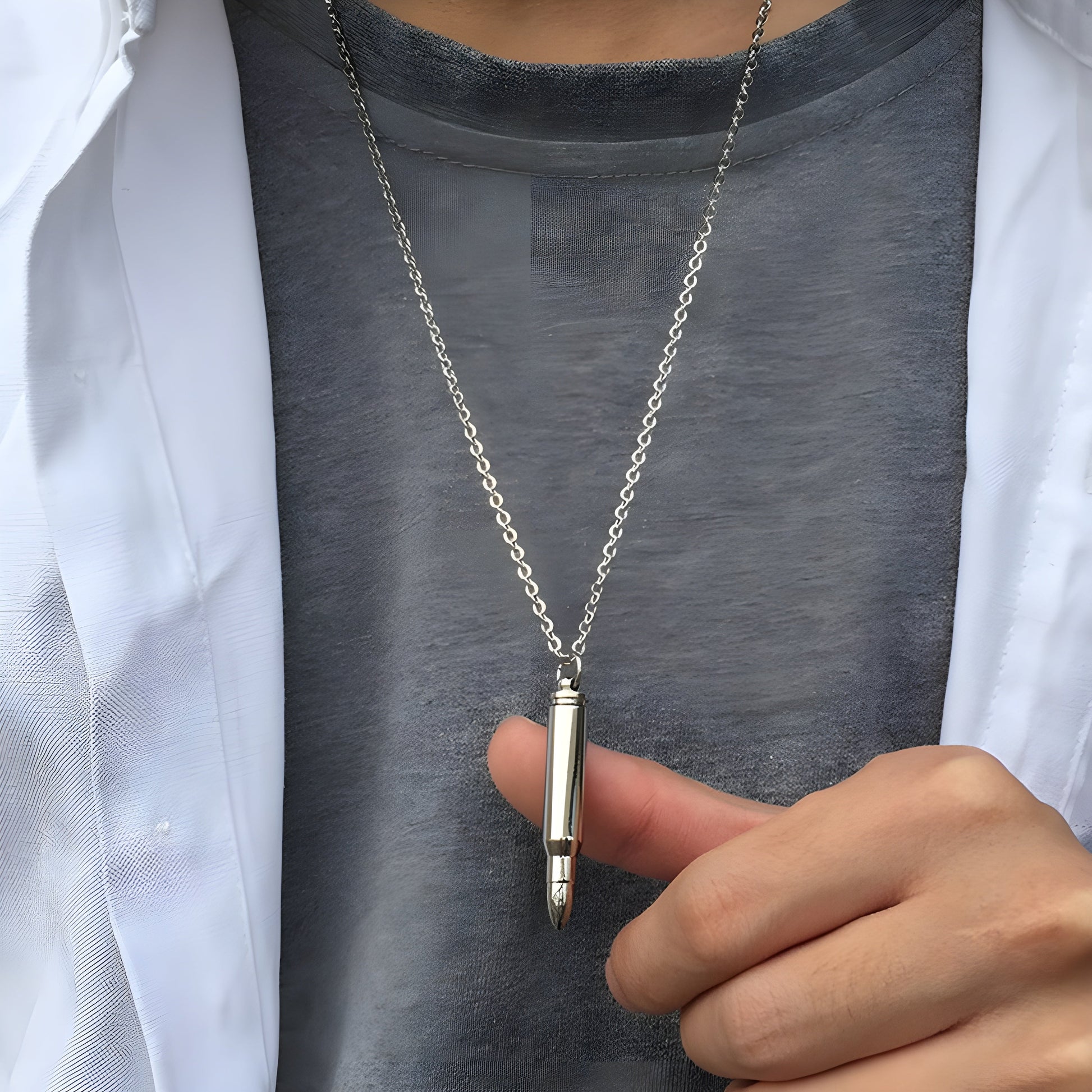 Man wearing a black bullet necklace, shown in a front view, highlighting the necklace's bold and rugged design.