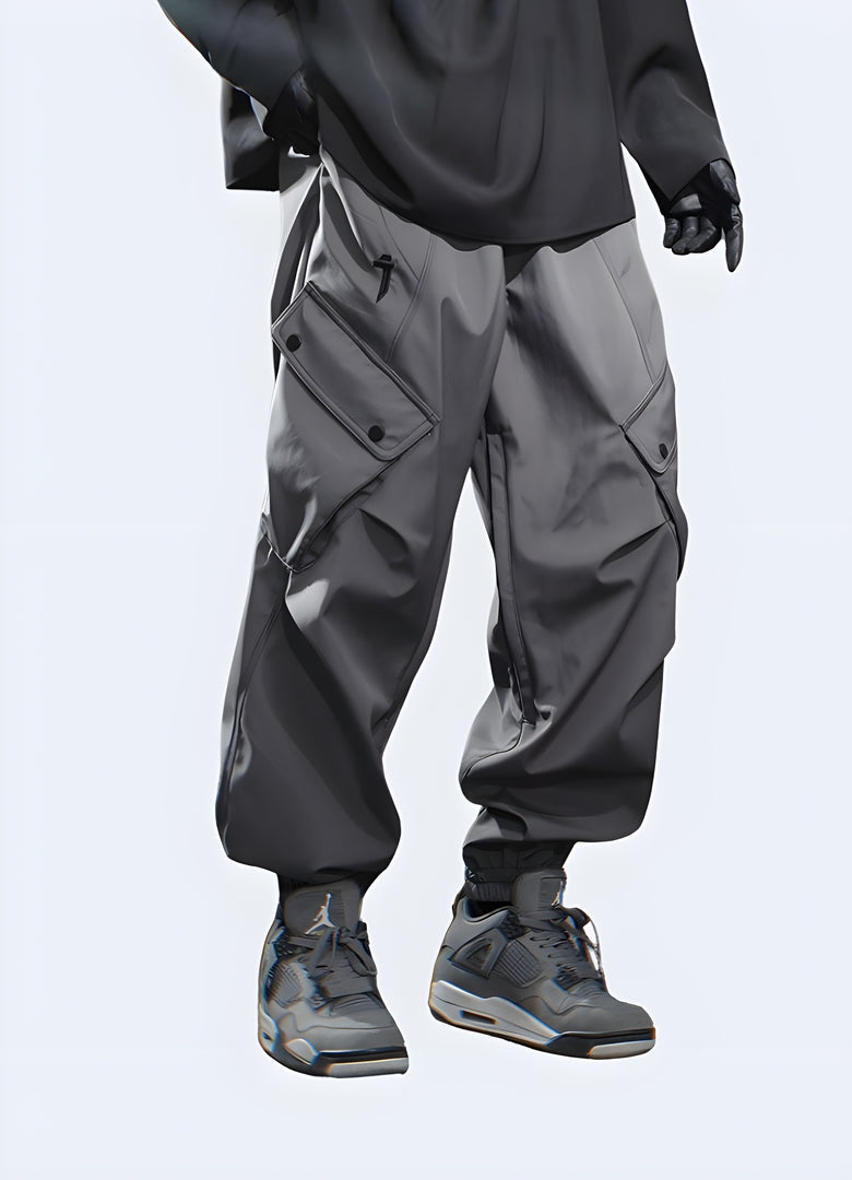 Side view of a man wearing dark grey cargo trousers, highlighting the design features and silhouette from the side.