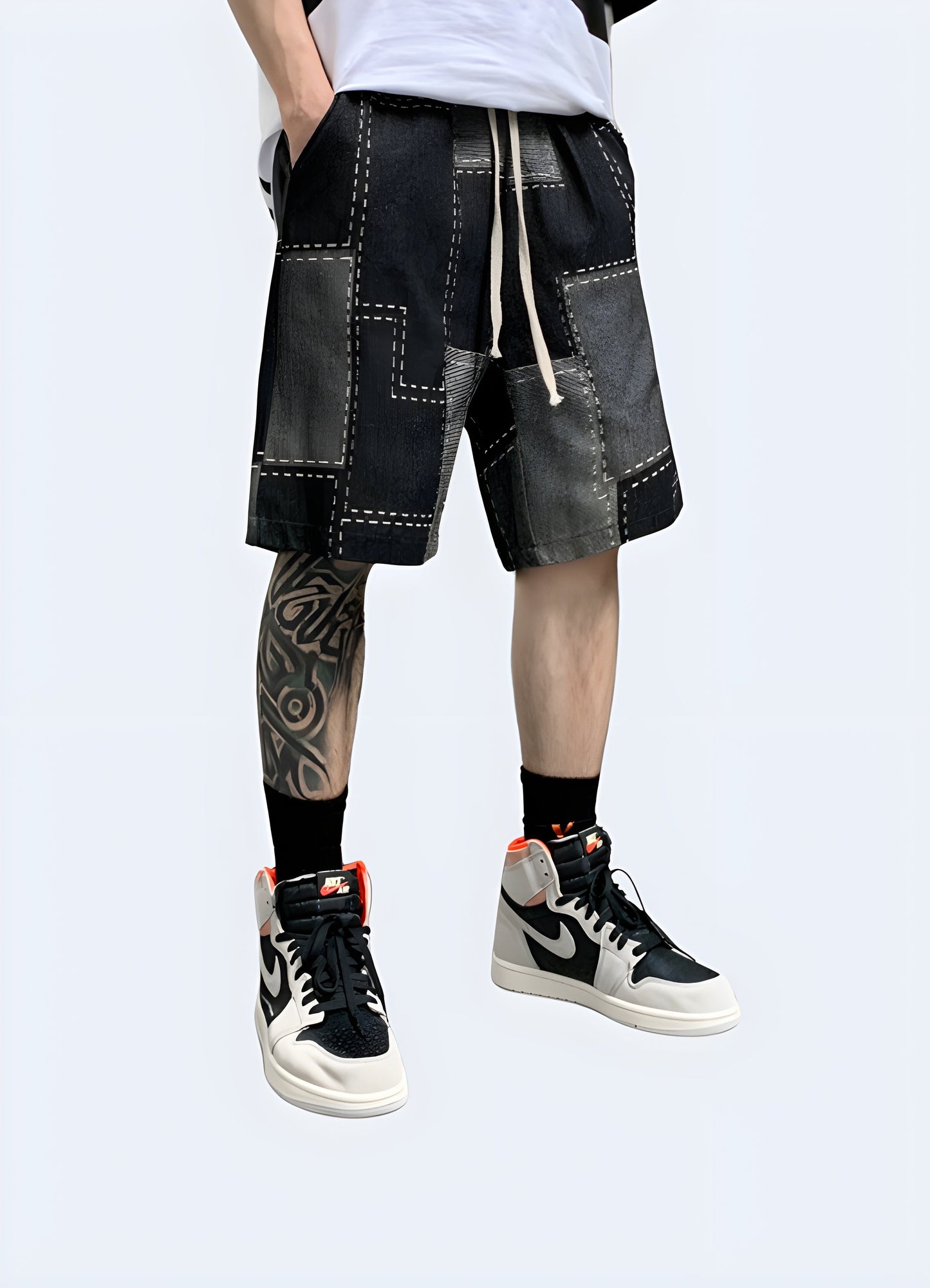 Front view of a man wearing denim patchwork shorts, showcasing the creative design and trendy look, perfect for the fashion-forward individual Canada.