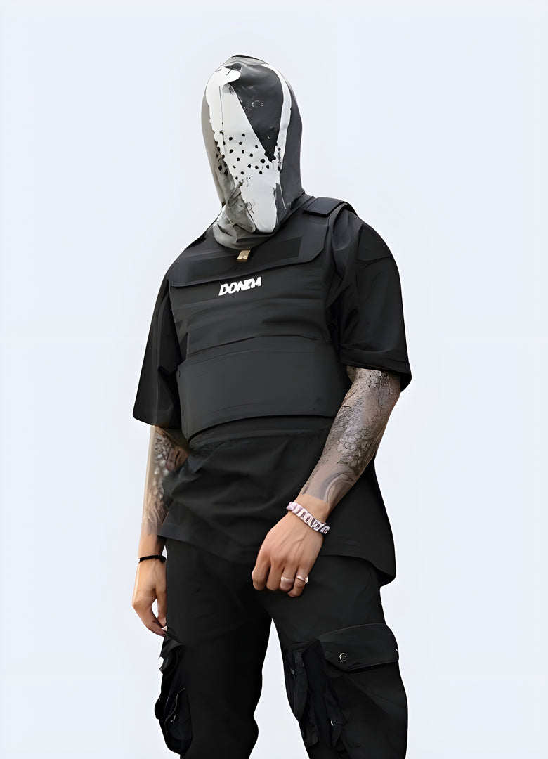 Front view of a man wearing a black Donda-style tactical vest with multiple pockets, adjustable straps, and a minimalist design, showcasing its versatility and style.
