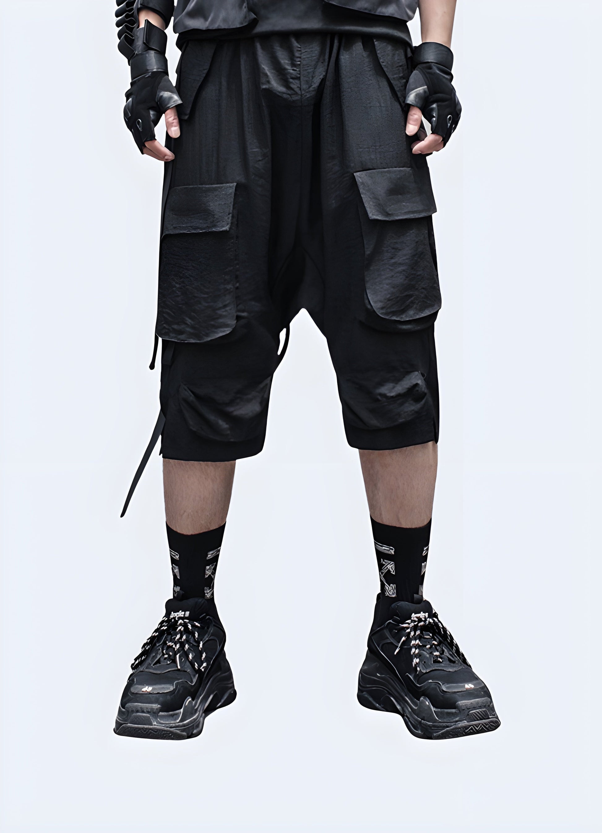 Front view of a man wearing innovative drop crotch techwear shorts, showcasing the garment's modern silhouette, technical features, and streamlined design that redefines contemporary fashion Canada.