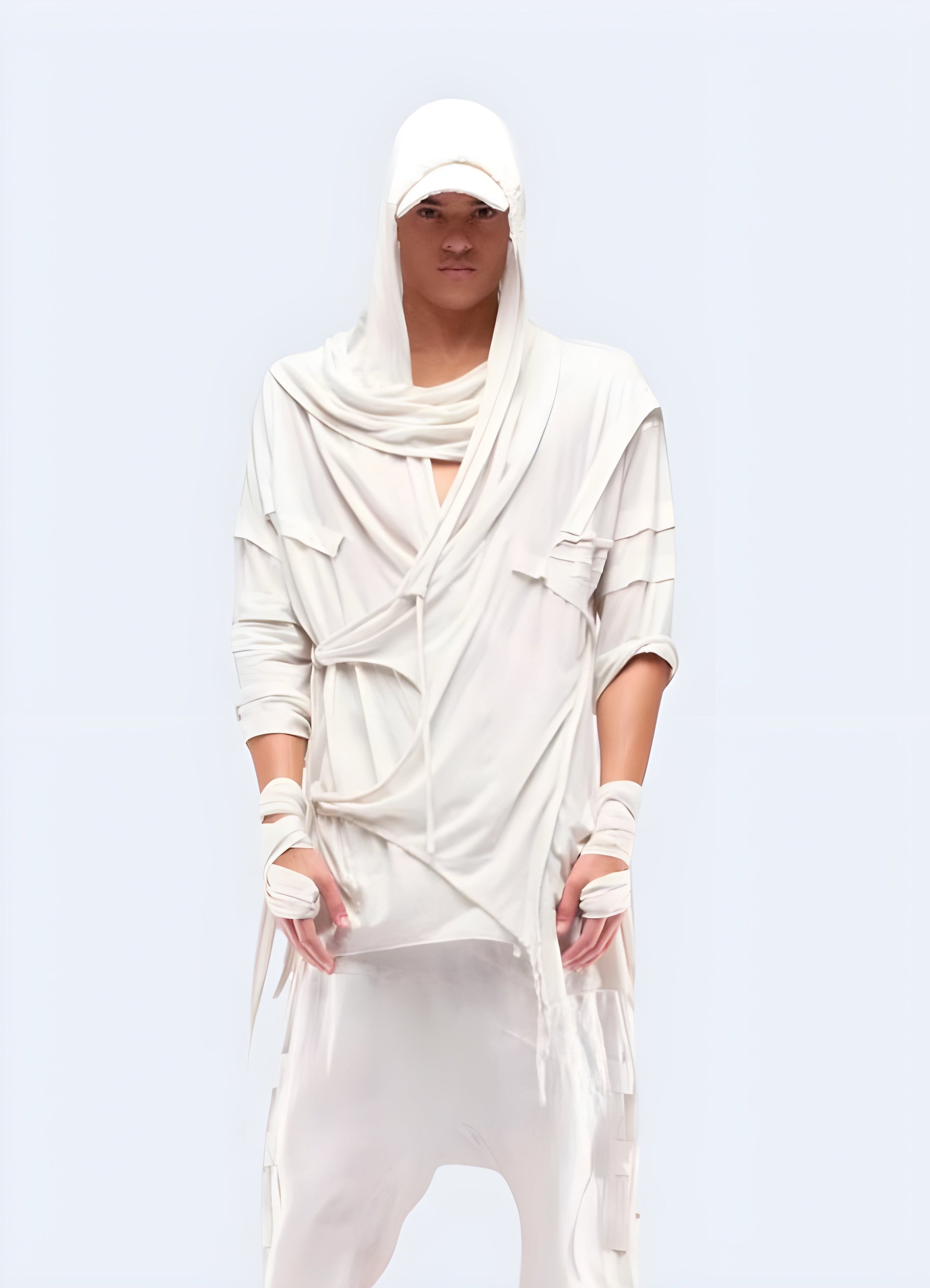 Front view of a man sporting a white dystopian asymmetric cloak, highlighting its striking contrast and avant-garde design, ideal for those who embrace a futuristic dystopian look in the Canada.