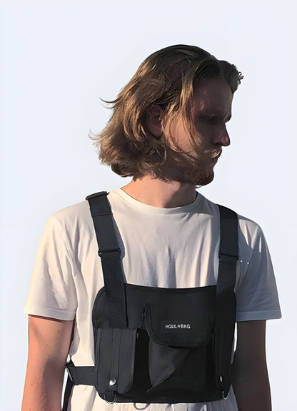 The pack's compartments, including zippers and any visible pockets, are clearly shown. The model's outfit and the front pack's design create a rugged, functional look Canada.