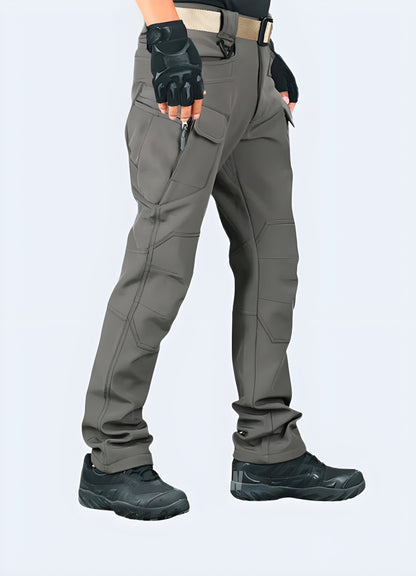 Side view of a man wearing grey gorpcore pants, highlighting the streamlined silhouette, practical pockets, and high-performance materials perfect for outdoor enthusiasts and fashion-conscious individuals in Canada.