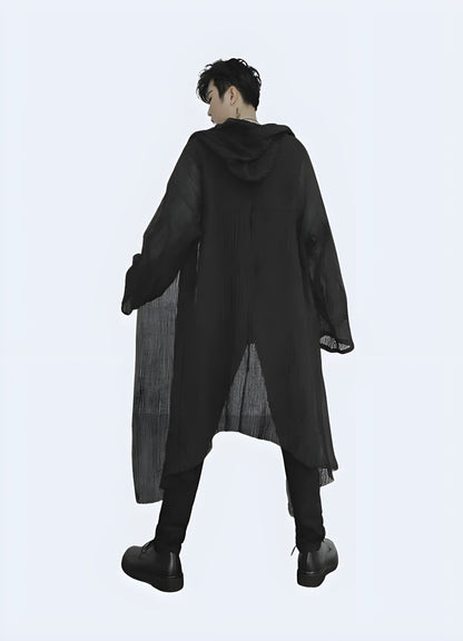 Back view of a man wearing a hooded streetwear cloak, highlighting its oversized silhouette and edgy aesthetics, ideal for elevating any streetwear outfit in the Canada.