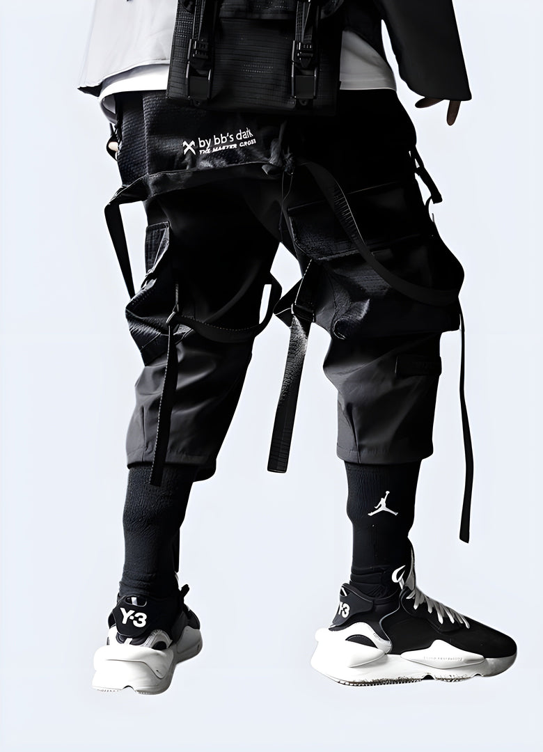 Rear view of a man modeling fashionable black streetwear pants, showcasing the garment's premium quality and attention to detail, ideal for the Canada streetwear scene.
