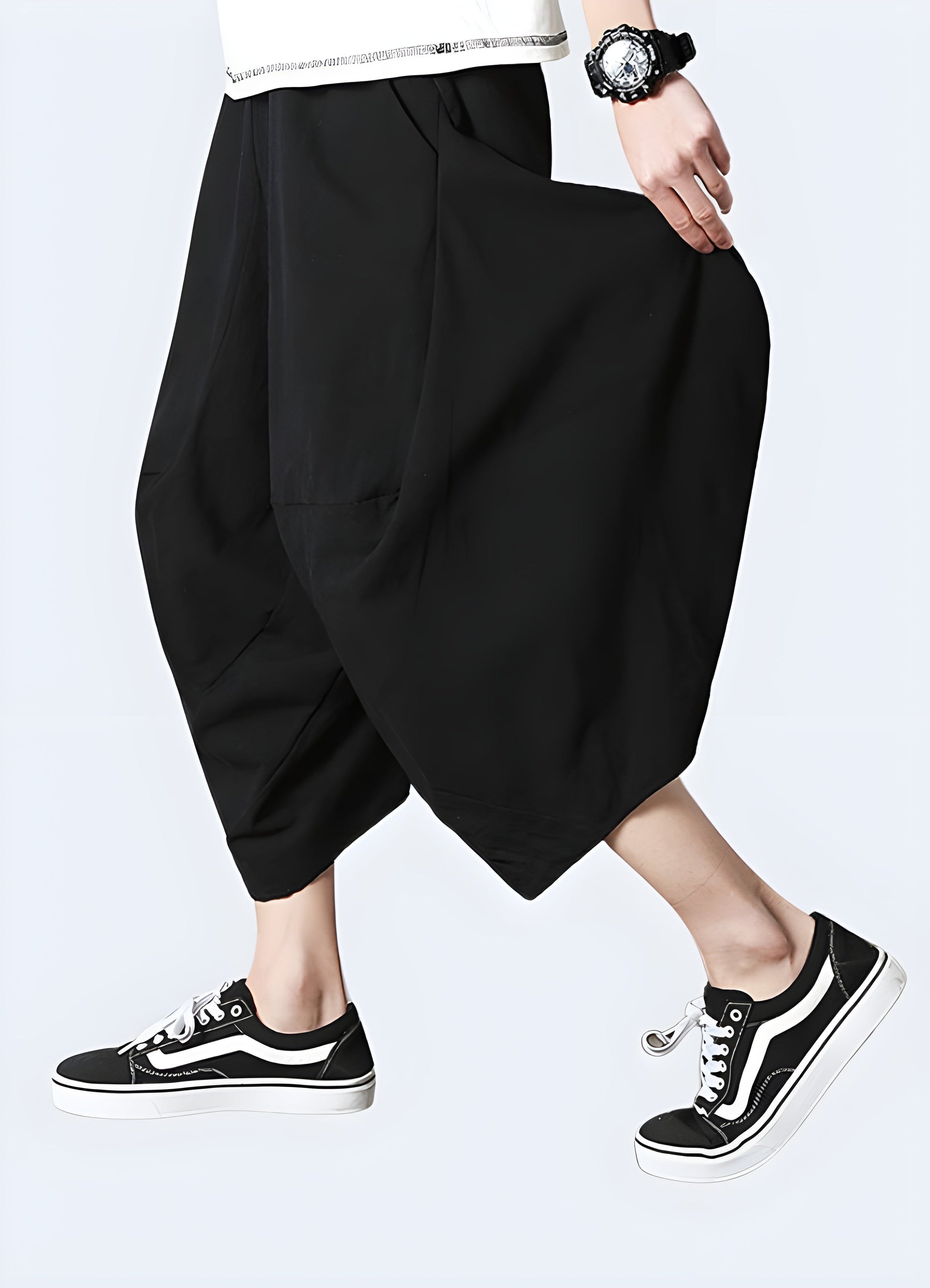 Side width view of a man modeling traditional Japanese harem pants, showcasing the garment's voluminous silhouette and unique design, perfect for fashion-forward individuals in the Canada seeking a distinctive look.