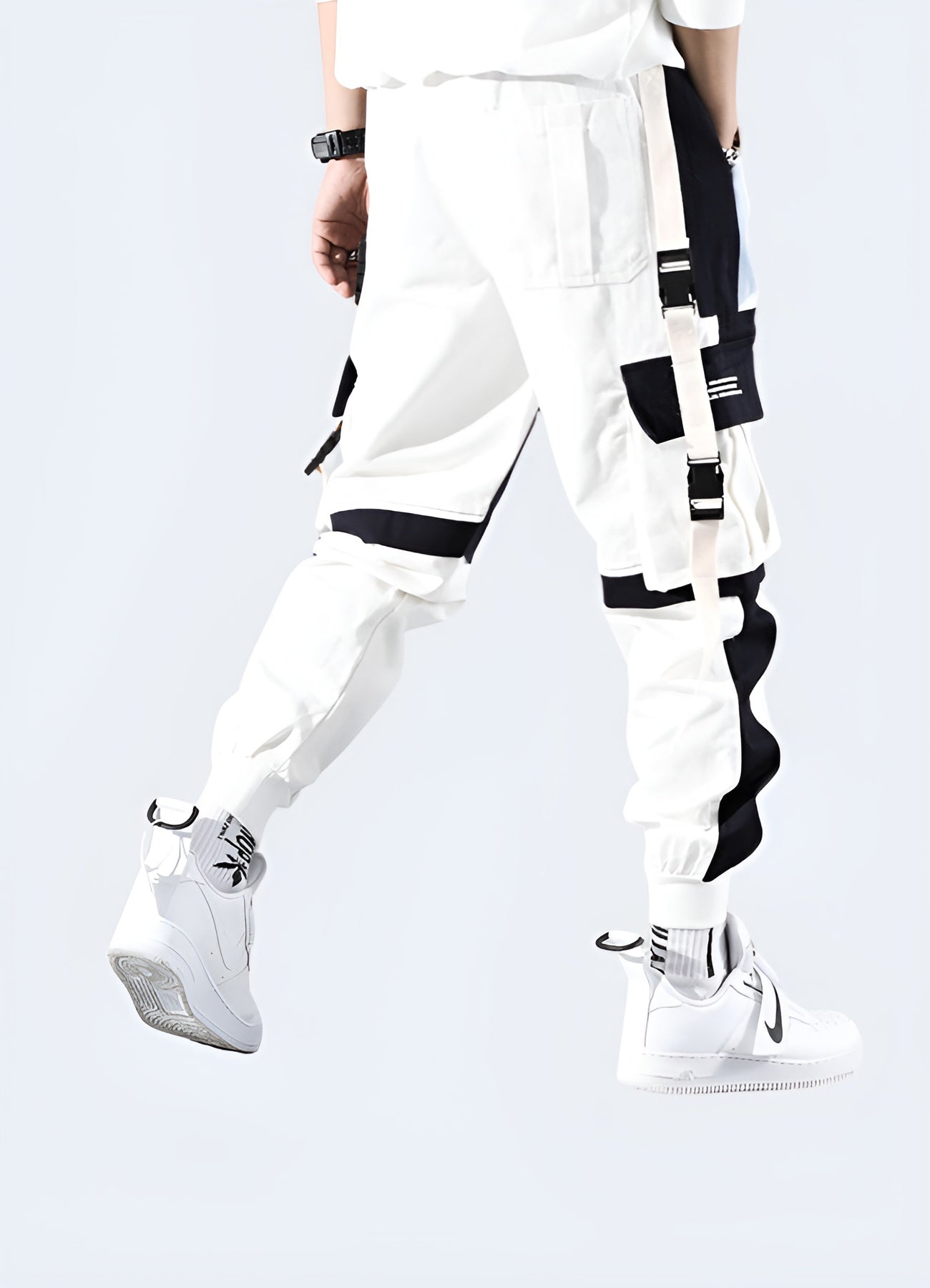 Back view of a man modeling high-performance white techwear pants, highlighting the garment's ergonomic fit and functional details, ideal for Canada consumers seeking a contemporary and practical look.