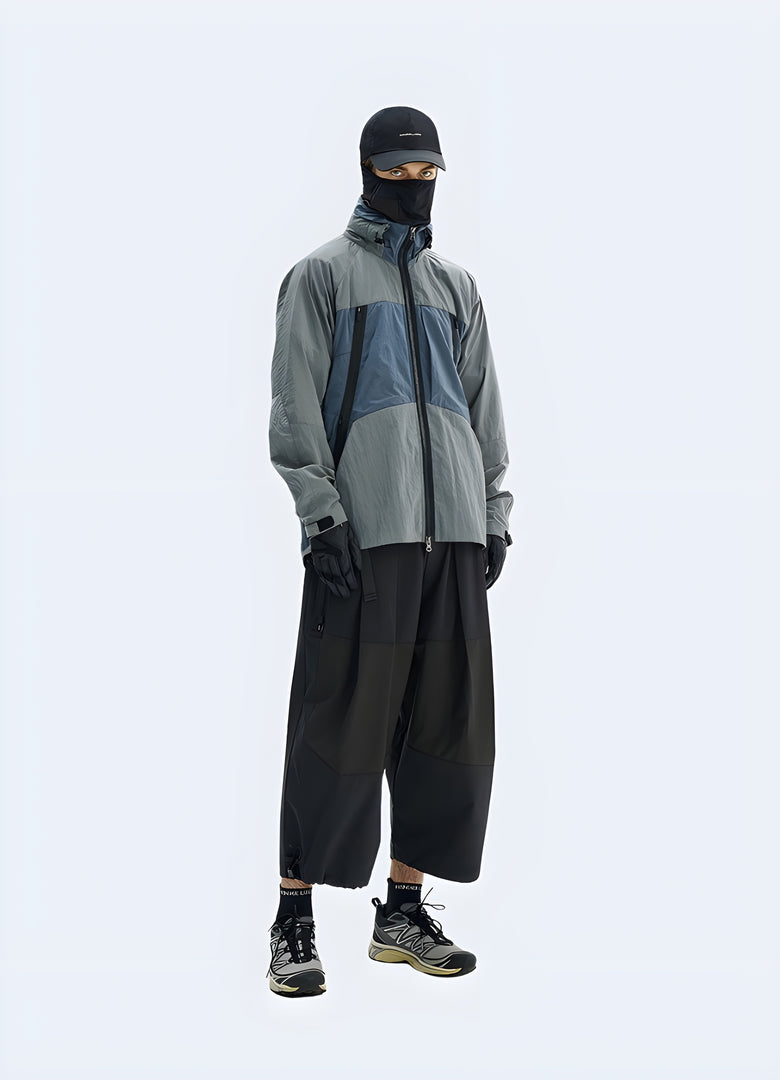 Man wearing a purple techwear jacket, showcasing the garment's unique side design and technical features, captured in the Canada.