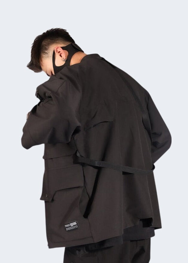 Back view of a man wearing a tactical kimono, showcasing the practical features and unique silhouette, ideal for the Canada fashion-conscious adventurer.