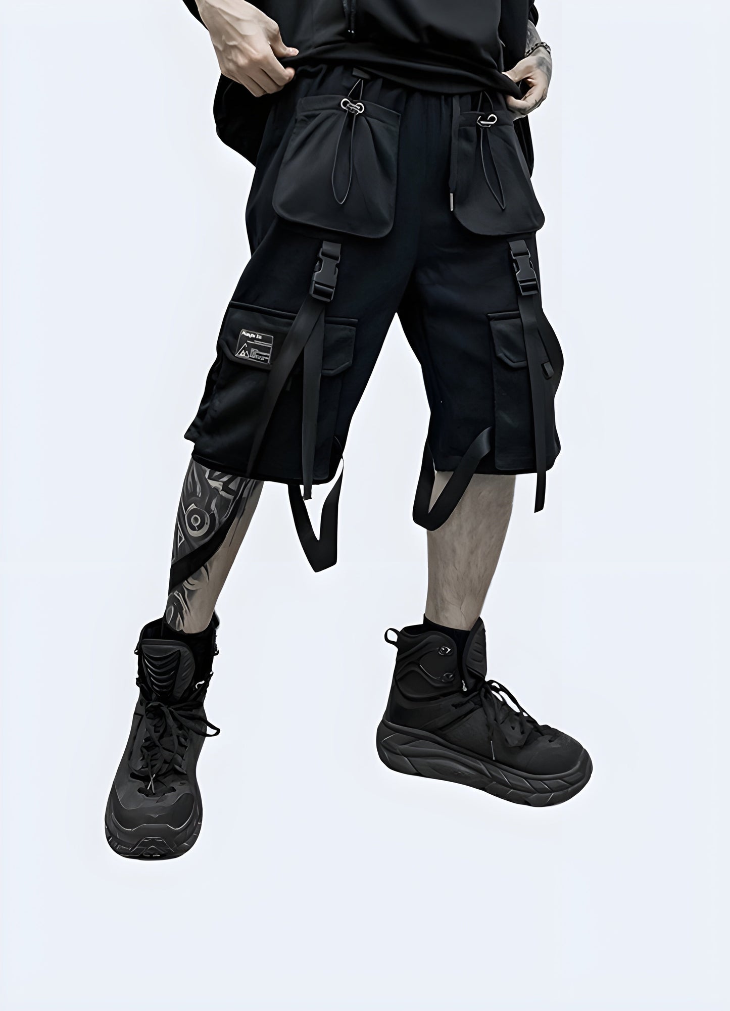 Front view of a man wearing black techwear cargo shorts, showcasing the modern design and practical features suitable for the streetwear scene.