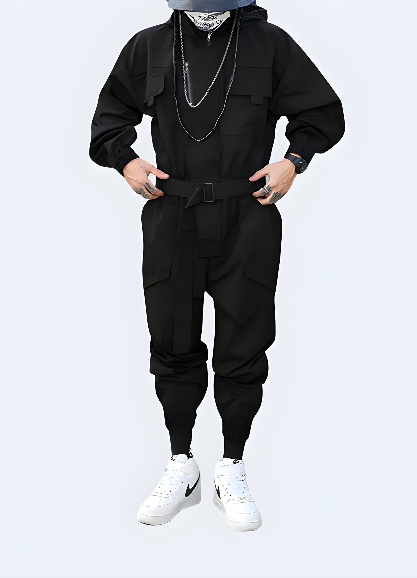 Front view of a man modeling a cutting-edge black techwear jumpsuit with multiple pockets and a hood, perfect for urban exploration and fashion-forward style in the Canada.