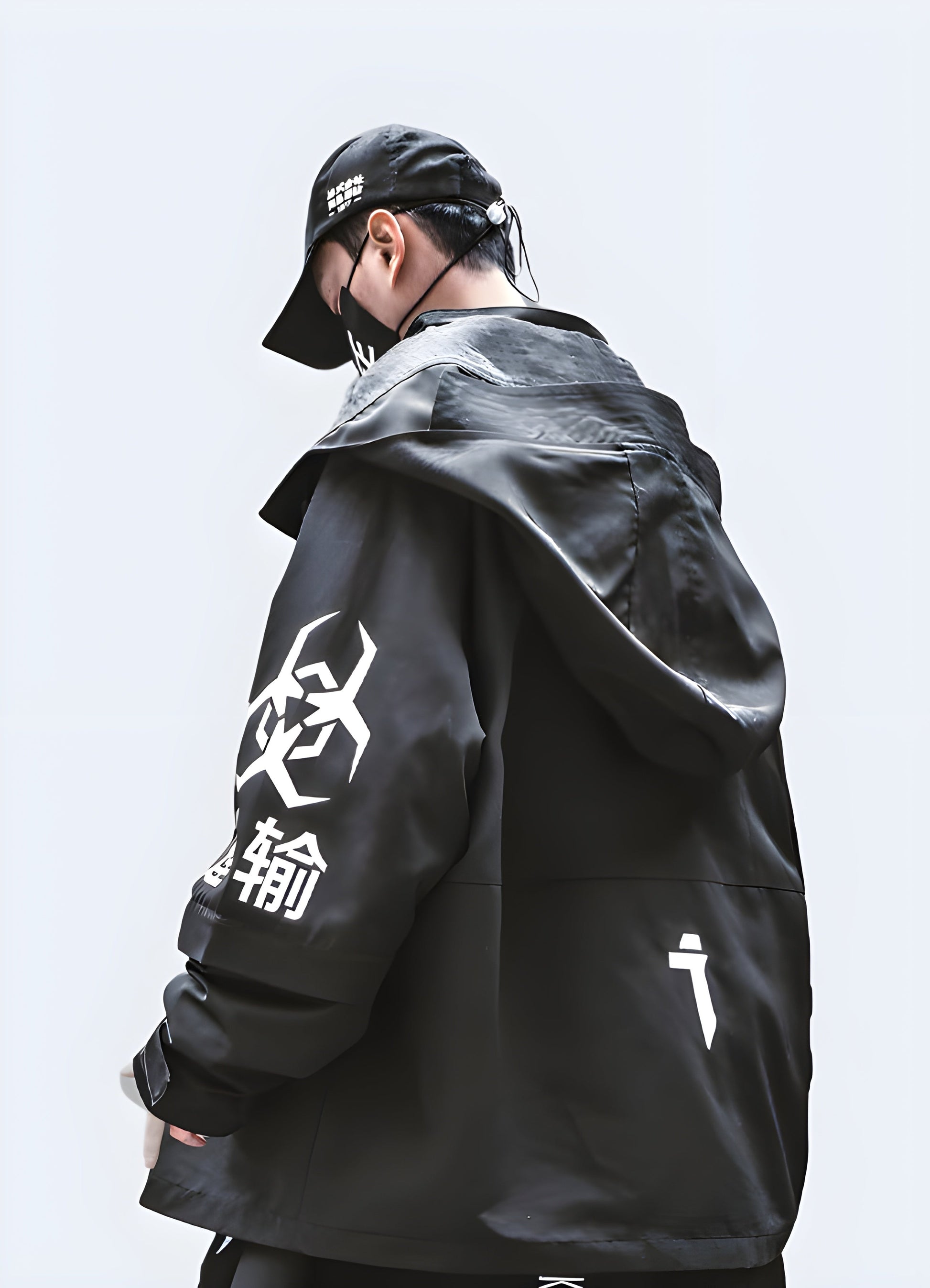 Back view of a man wearing a techwear oversized jacket, showcasing its unique silhouette and advanced features, perfect for Canada urban fashion scene.