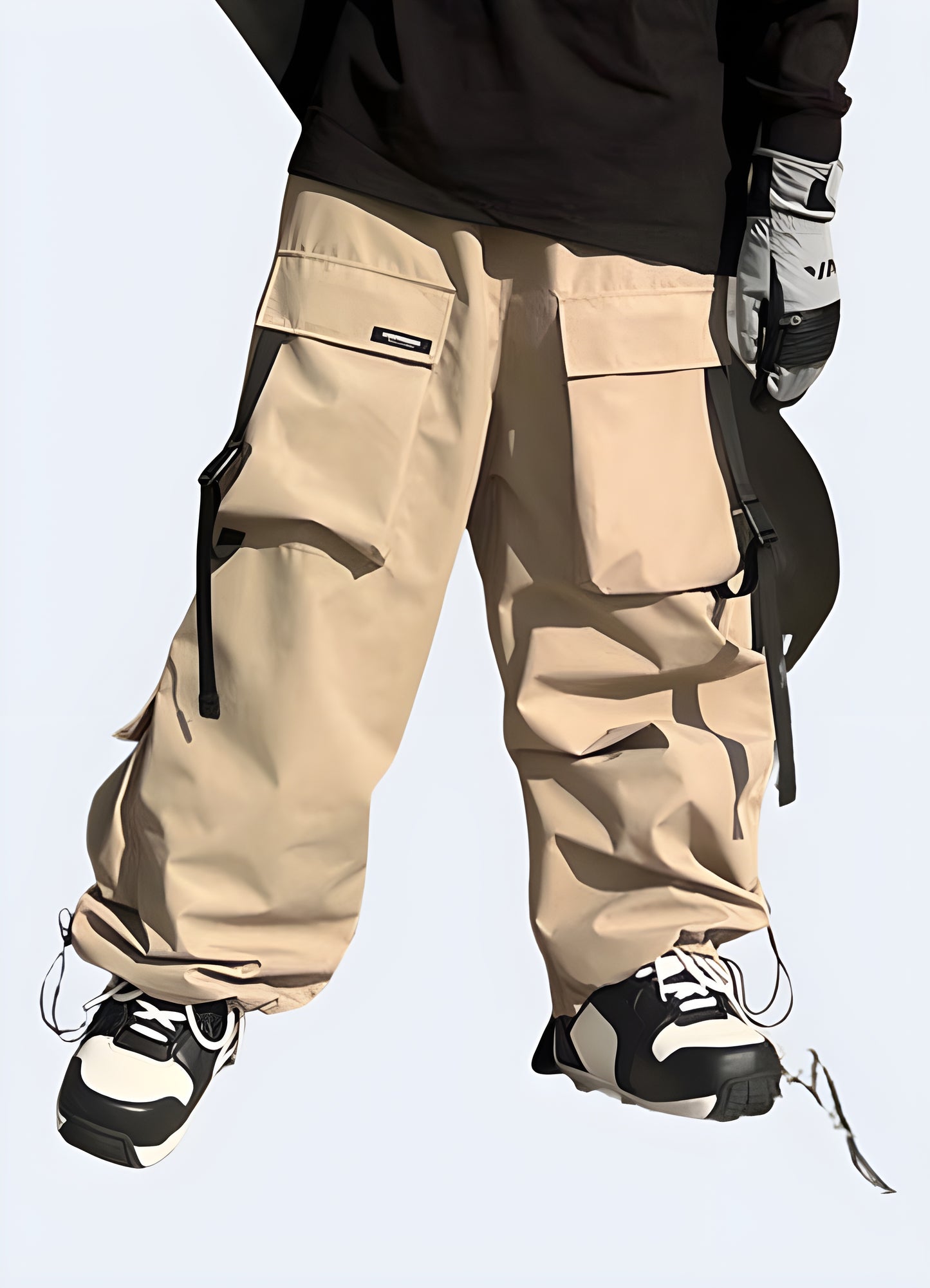 Man wearing khaki techwear ski pants, front view, demonstrating the perfect blend of style and performance for Canadian winter adventures.