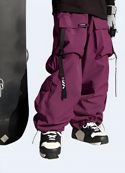 Man wearing techwear ski pants in striking violet, front view, emphasizing their cutting-edge style and utility, available in Canada.