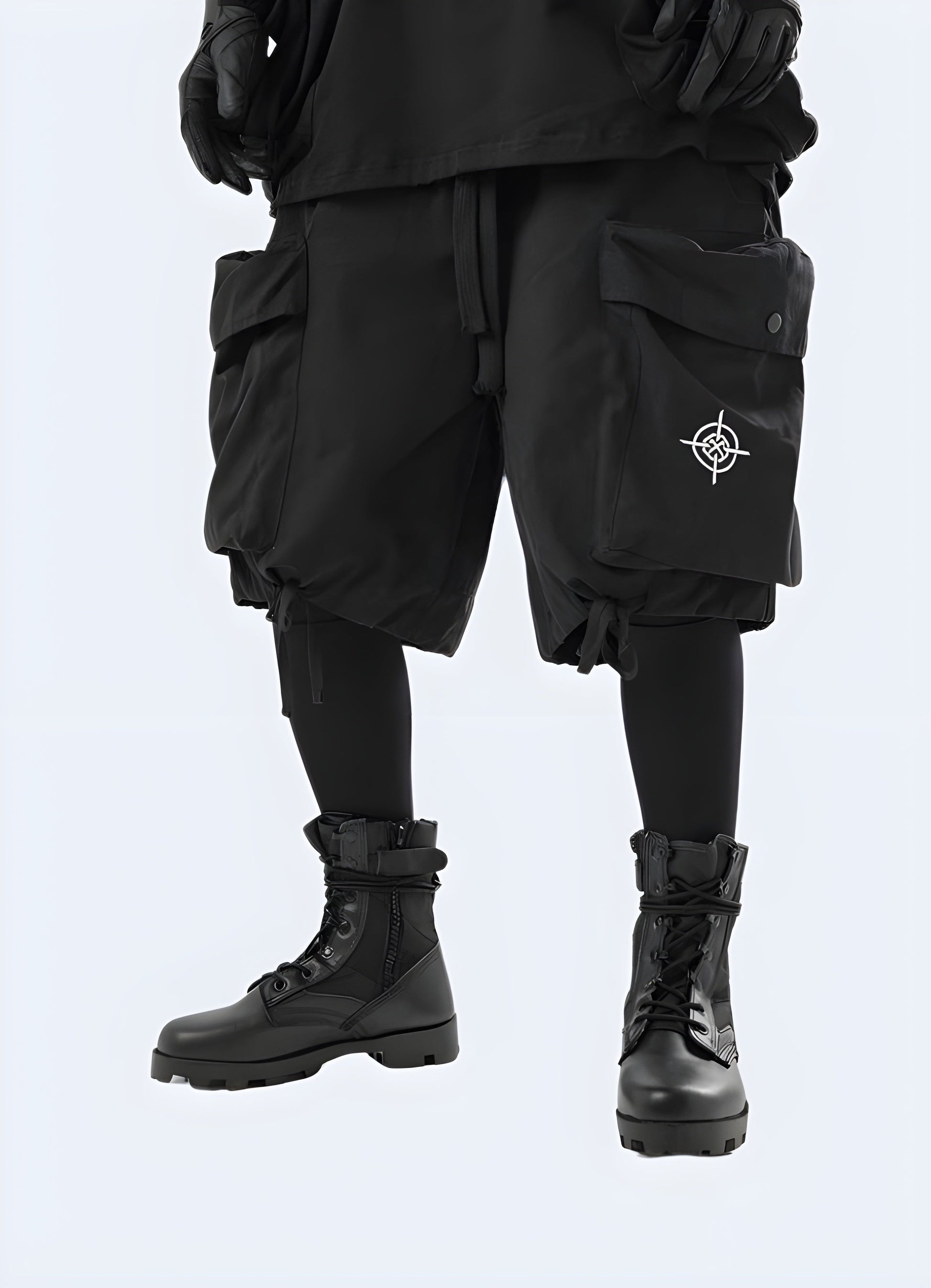 Front side view of a man wearing black tie up techwear cargo short, showcasing the rugged design and practical features suitable for the Canada outdoor enthusiast.