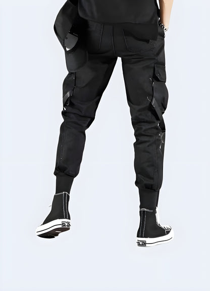 Back view of a man wearing urban ninja pants, showcasing the streamlined silhouette, functional design elements, and stealthy appearance ideal for navigating Canadian cities with ease and style.