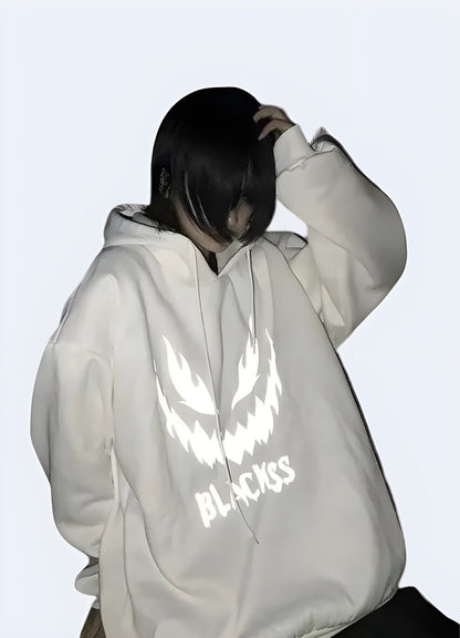 Man wearing white reflective hoodie, front view, available in Canada, highlighting its modern design and high-visibility features.