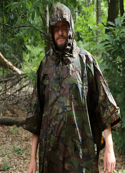 The poncho features a rugged, camouflage pattern designed for blending into the dense foliage.