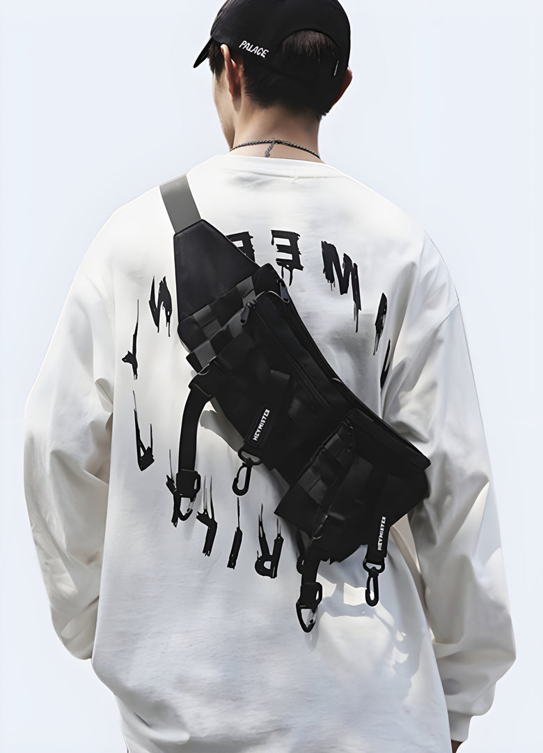 The front view highlights the bag's sleek, functional style and how it integrates into the man’s outfit, with a focus on its techwear aesthetic Canada.