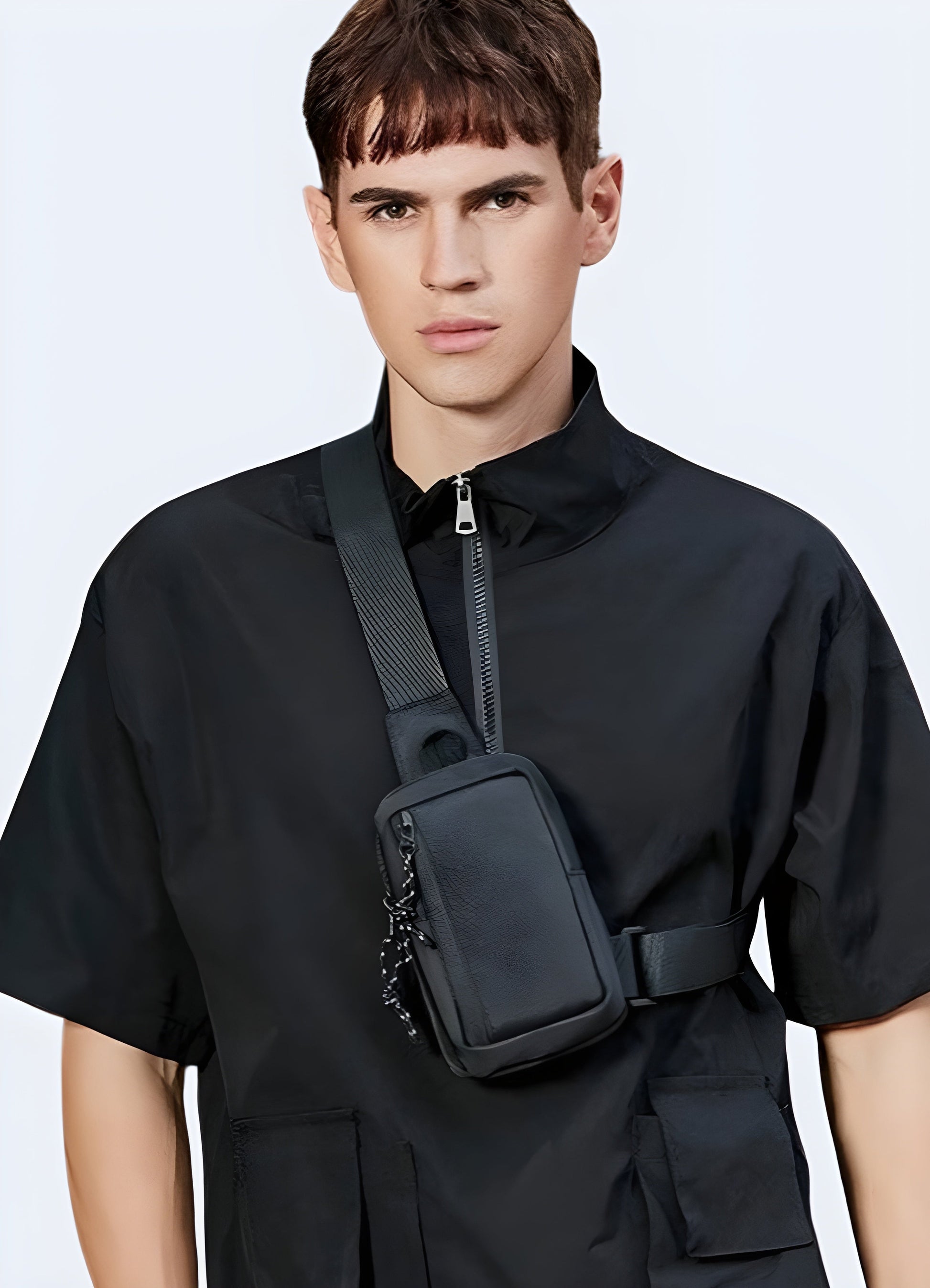 The front view highlights the bag’s functional style and how it complements the man's outfit, with the strap crossing from one shoulder to the opposite side Canada.