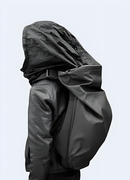 A man wearing a hooded backpack, viewed from the front and side. The backpack features a hood design and a modern, sleek appearance Canada.