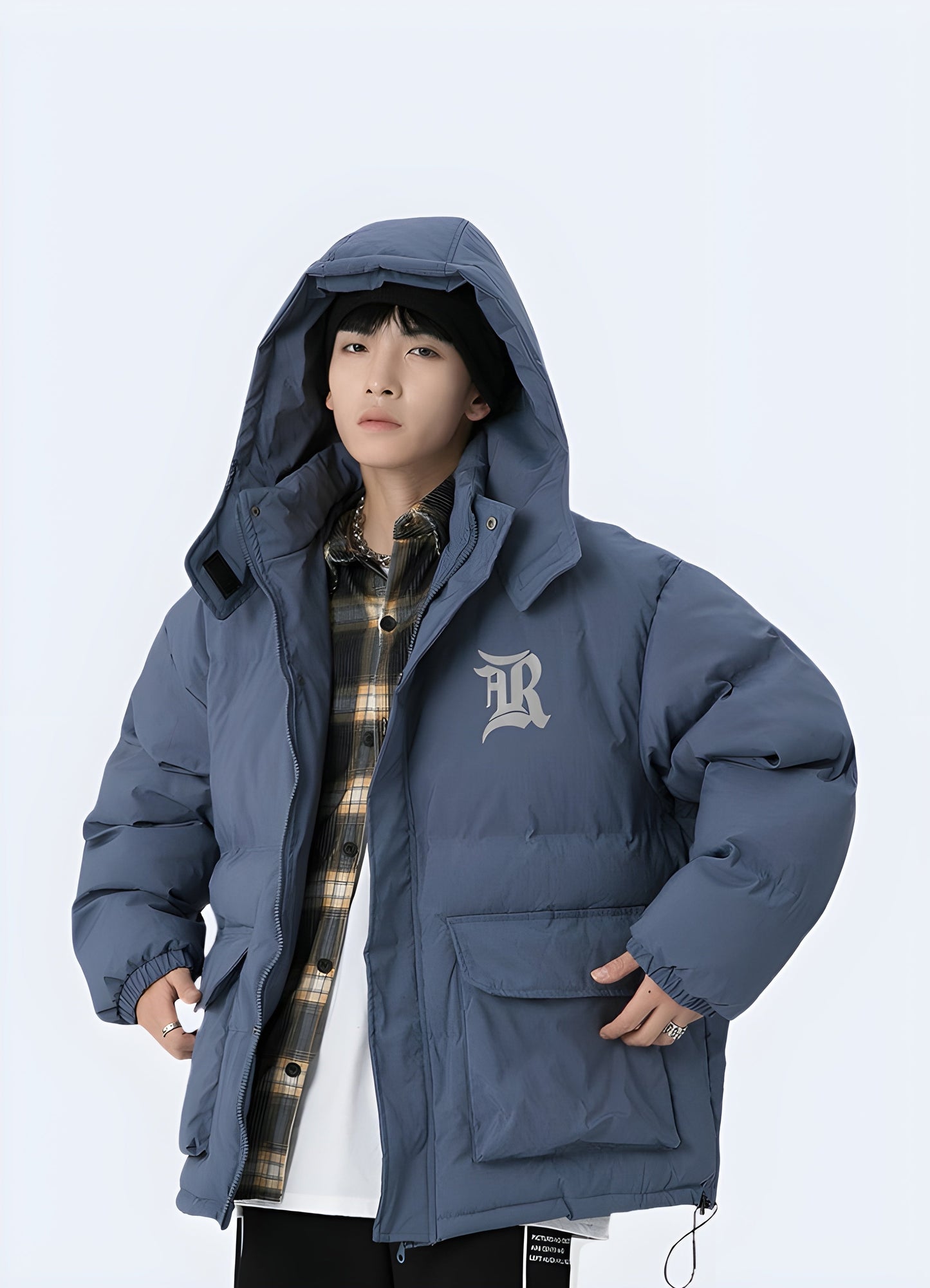 Man wearing a cutting-edge blue Korean techwear jacket with an open front, revealing its advanced technical features and stylish design, perfect for facing Canada's diverse weather conditions.