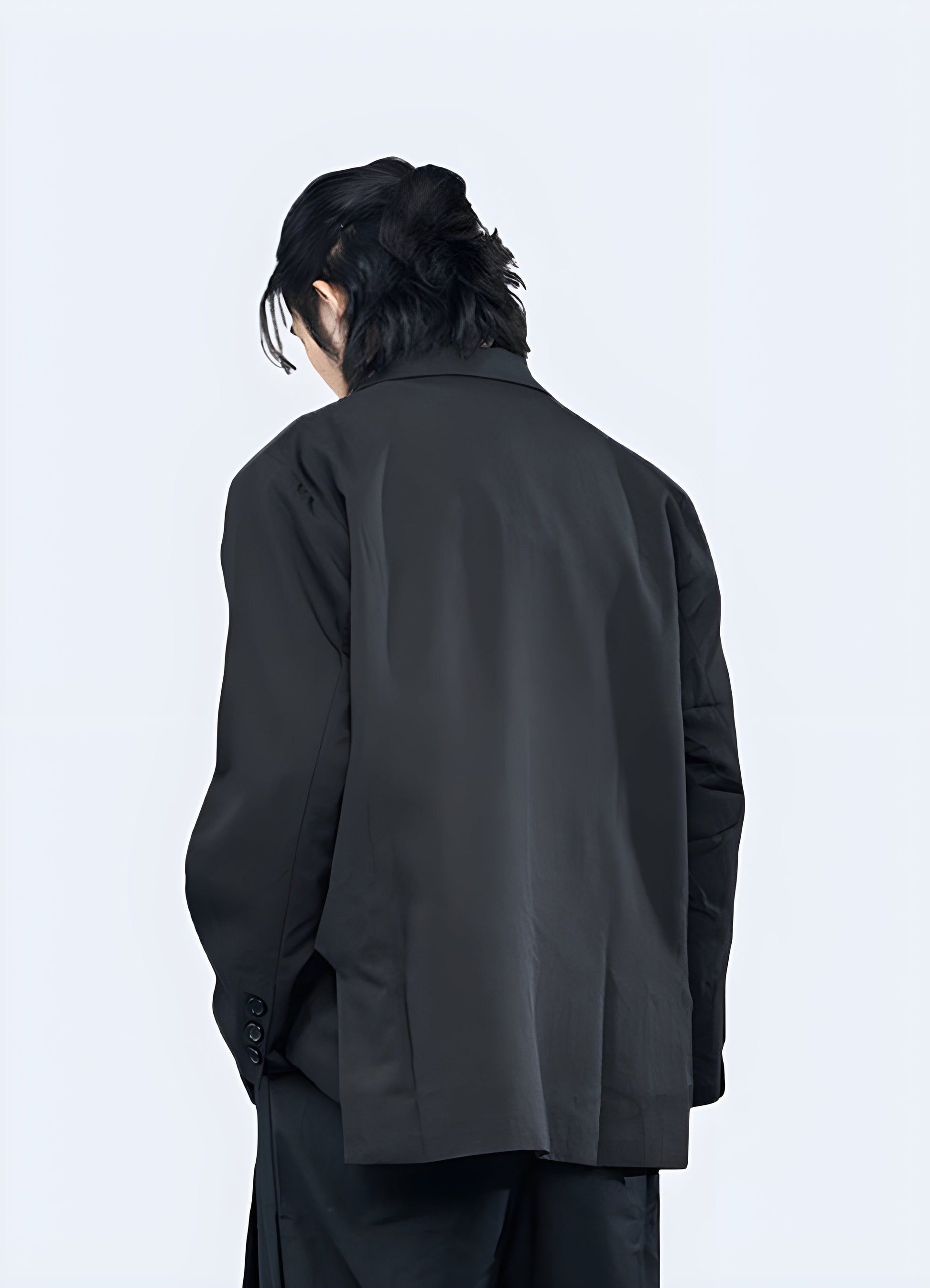 Back view of a man modeling a sophisticated minimalist blazer, ideal for anada professionals seeking a refined look.