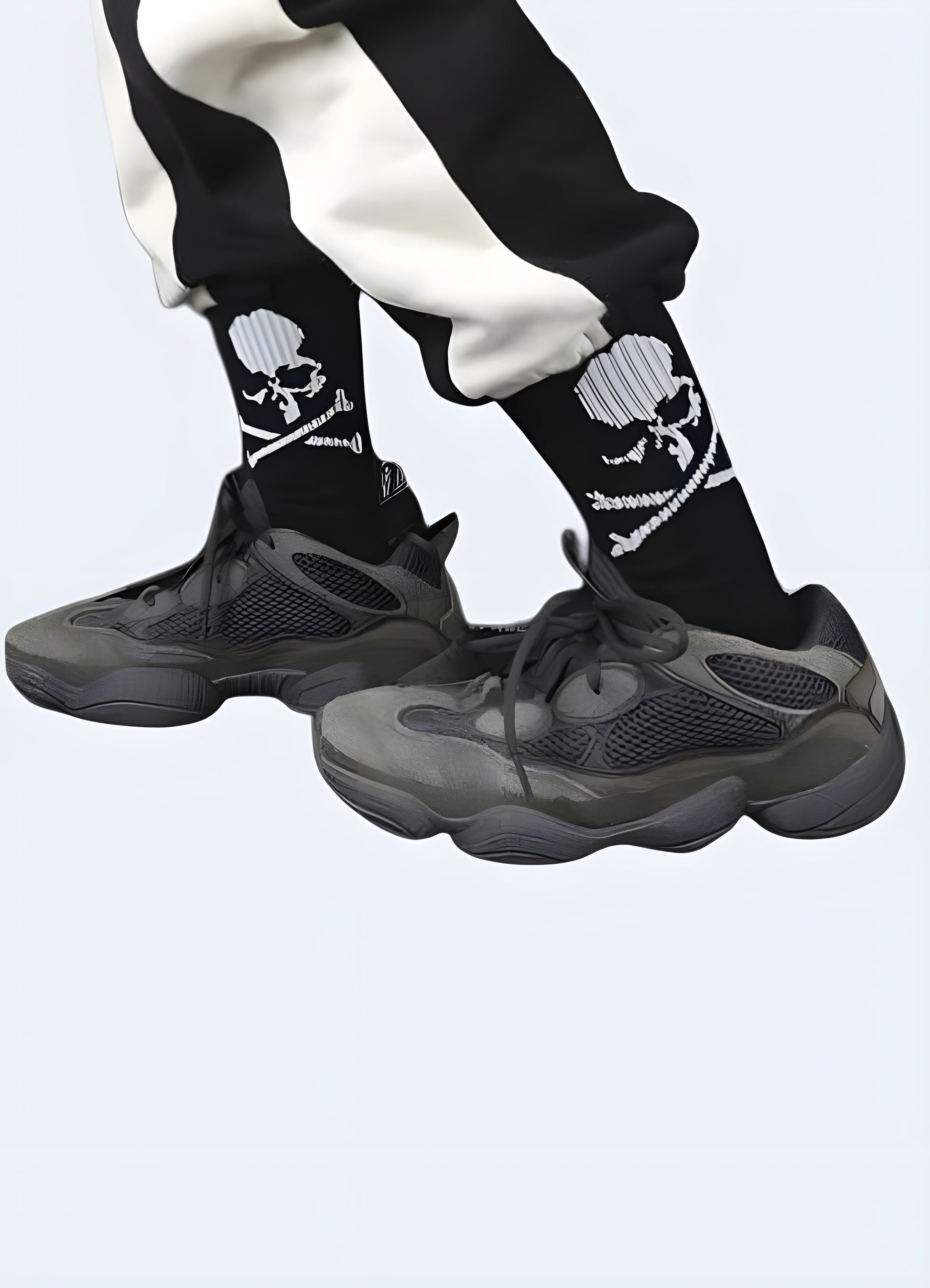 Side view of a man wearing black skull street socks in the Canada. Edgy and fashionable sock design for men.