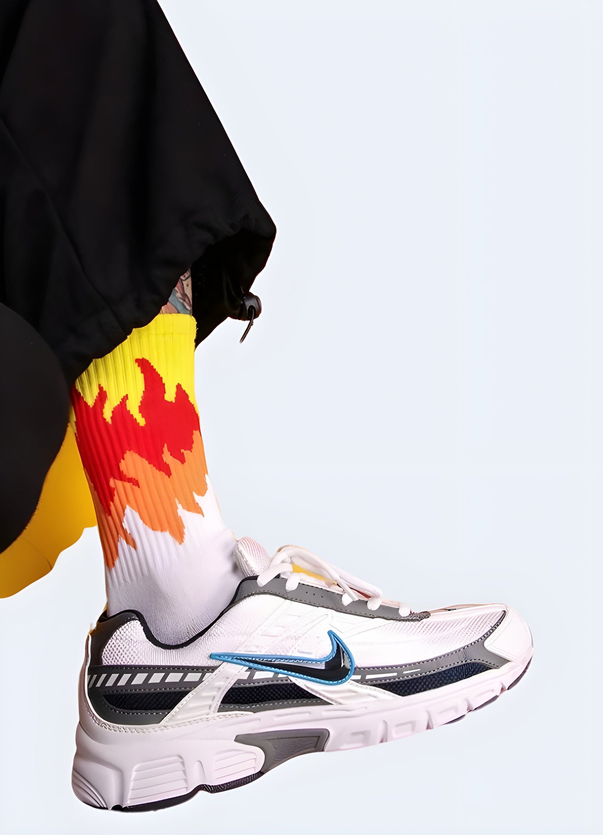 Men wearing white socks with striking flame designs, displayed from the side view, highlighting the trendy and daring style that caters to the tastes of Canada streetwear fans.