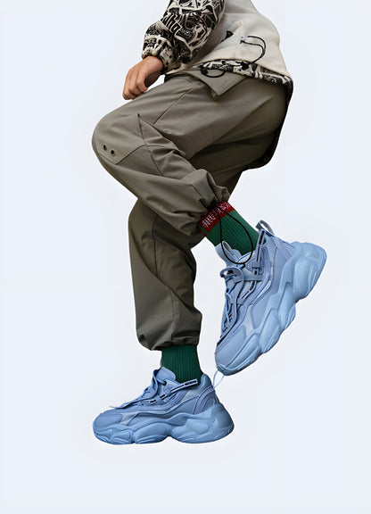 Man in Canada wearing blue techwear chunky sneakers from the side, emphasizing their modern design and urban appeal.