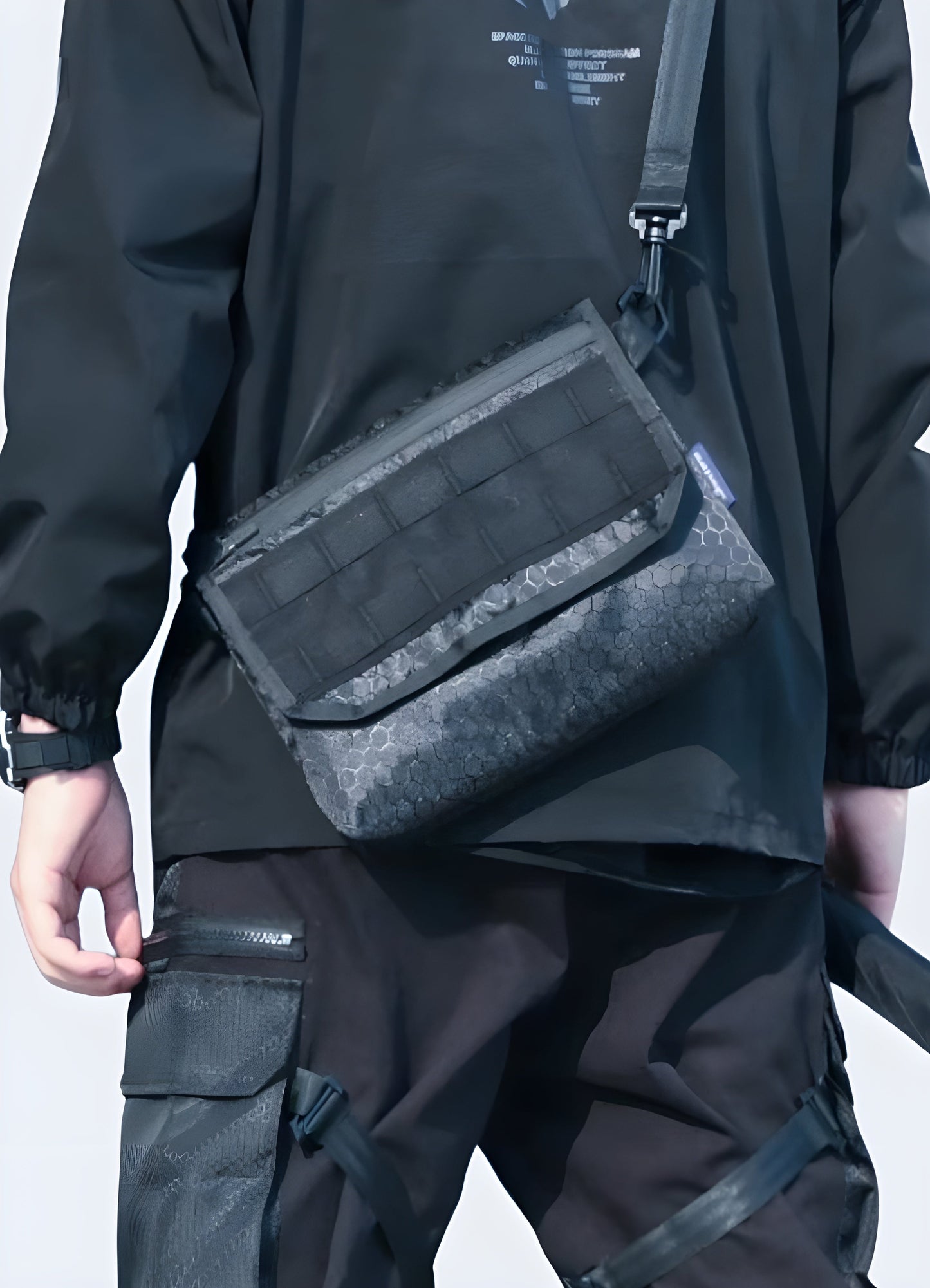 Man wearing a techwear shoulder bag, front view, highlighting urban style. Perfect for a modern and functional outfit Canada.