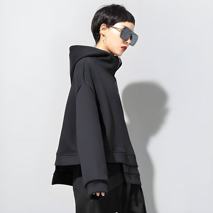 The hoodie features a unique, angular design with uneven hems and a modern, sleek silhouette typical of techwear fashion Canada.