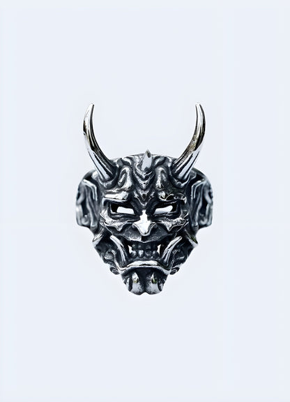 A model wearing an Oni ring, displayed from the front view, highlighting the intricate demon face design and the bold presence of the ring on the finger Canada.