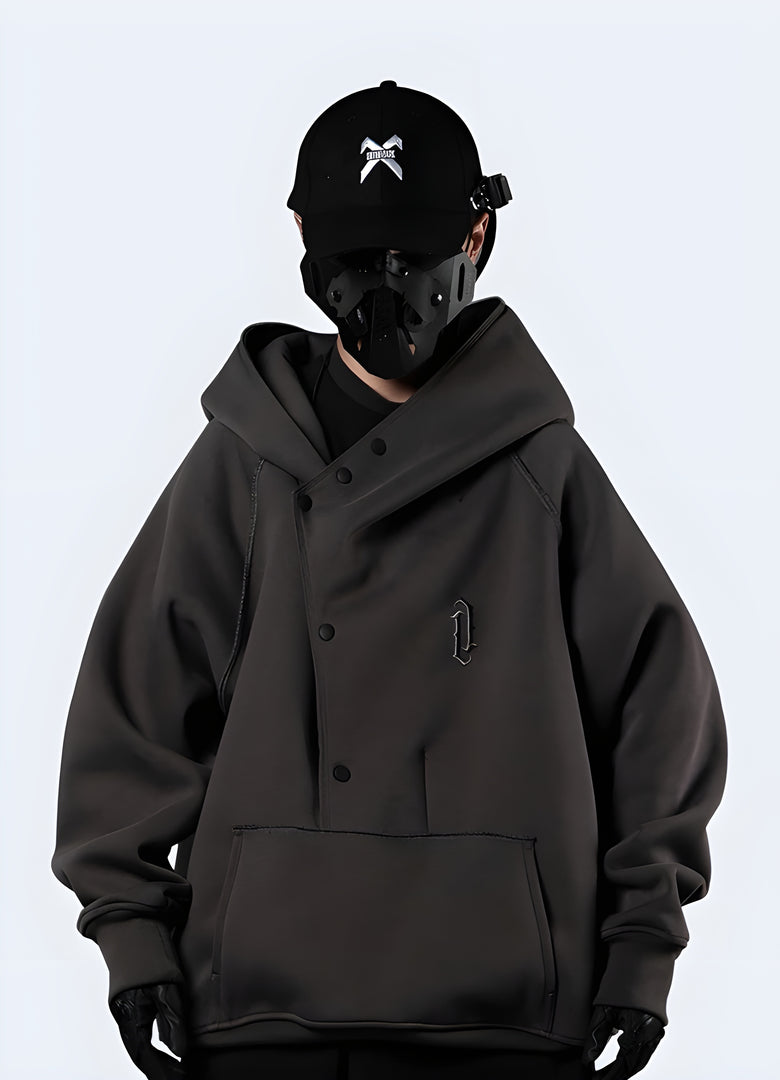 The hoodie is made of soft, high-quality fabric in a muted color, with a spacious kangaroo pocket and a drawstring-adjustable hood.